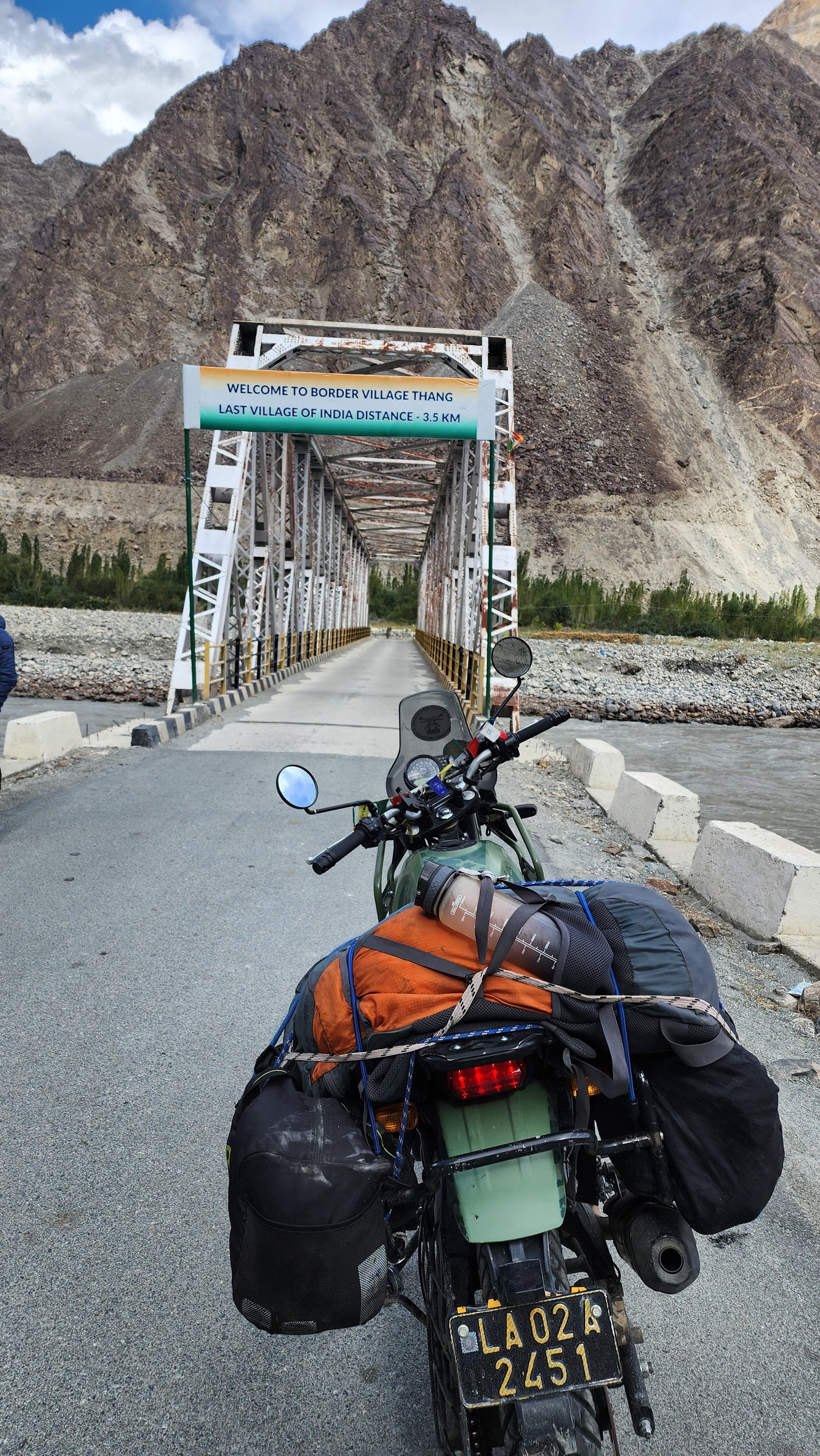 Motorcycle at a bridge entrance toward a remote Ladakh border village